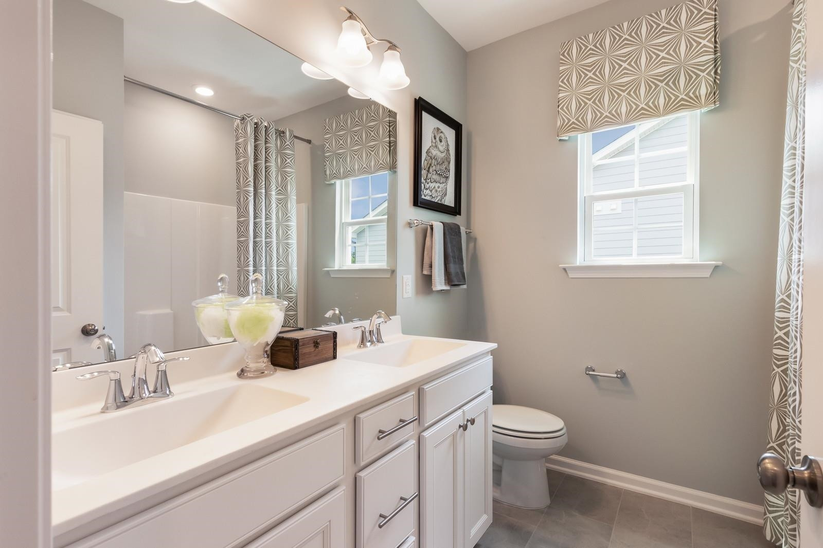 4121 Snowy Range Circle, Unit LANDRUM Raleigh, NC 27616 - Photo 21 of 27 a bathroom with a double vanity sink toilet and a mirror