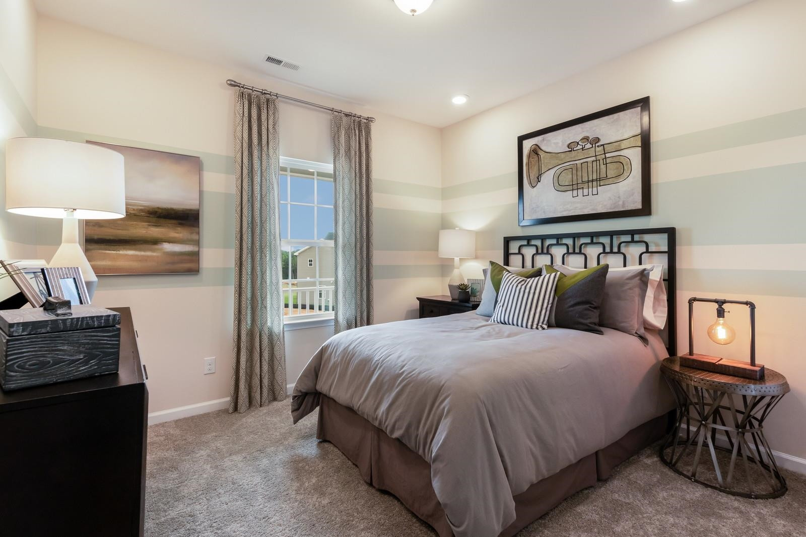 4121 Snowy Range Circle, Unit LANDRUM Raleigh, NC 27616 - Photo 23 of 27 a bedroom with a bed and wooden floor