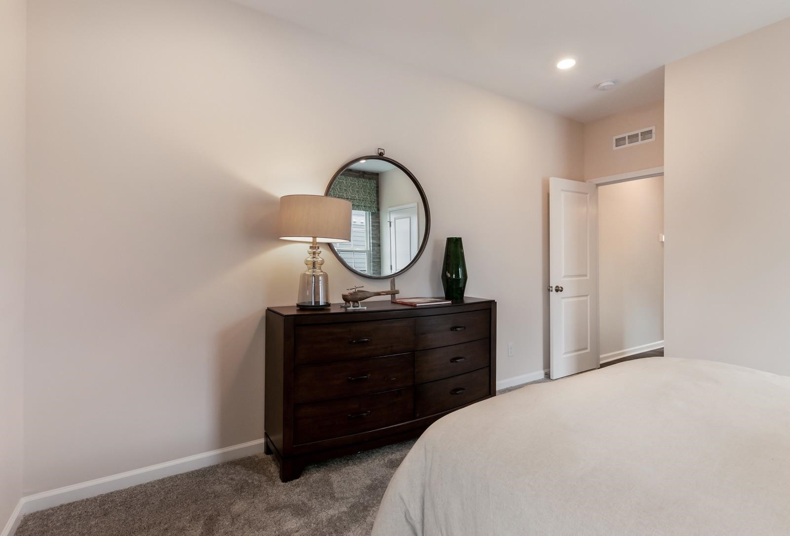 4121 Snowy Range Circle, Unit LANDRUM Raleigh, NC 27616 - Photo 25 of 27 a bedroom with a bed and a dresser