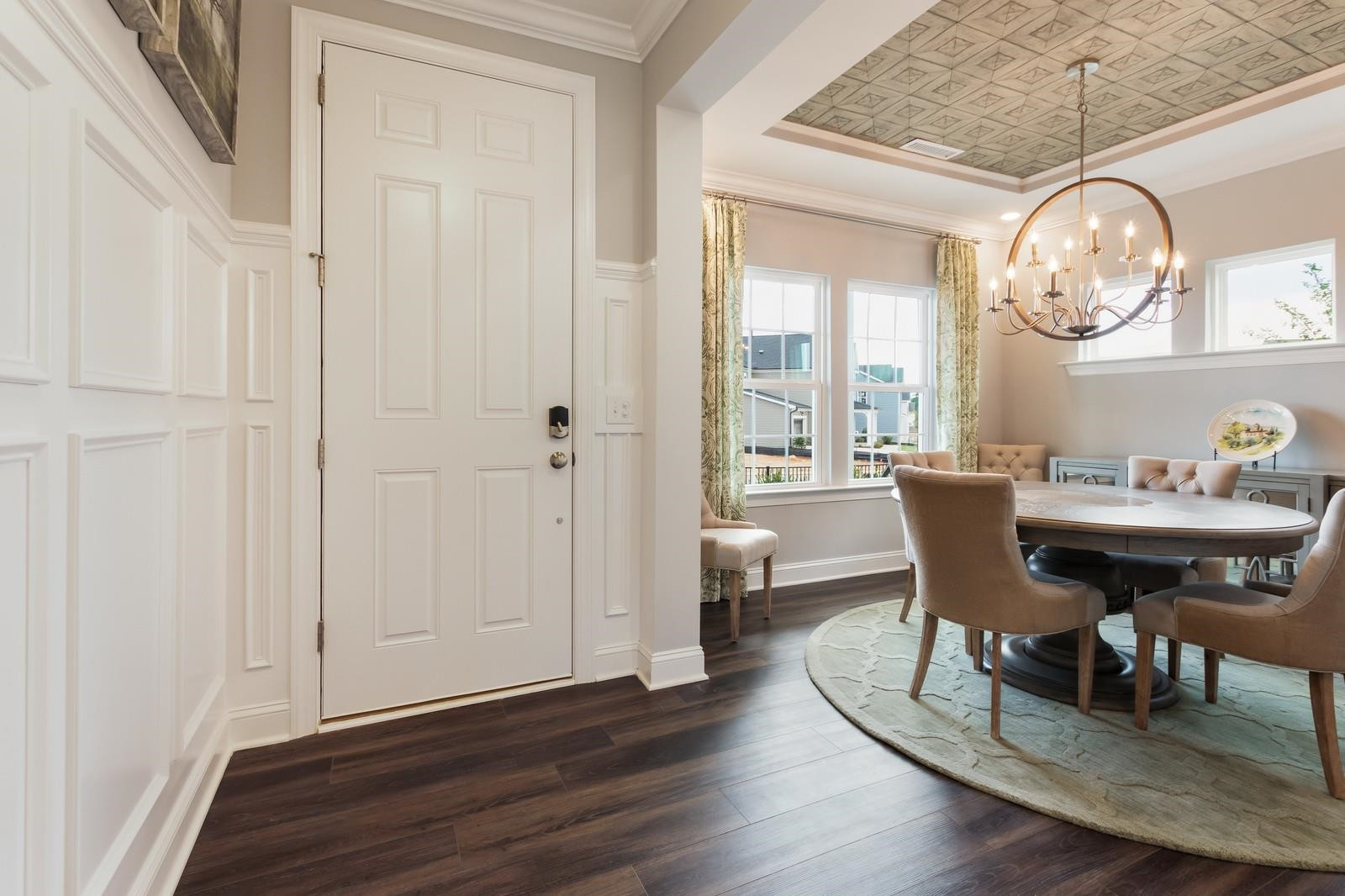 4121 Snowy Range Circle, Unit LANDRUM Raleigh, NC 27616 - Photo 5 of 27 a view of a dining room with furniture a chandelier and wooden floor