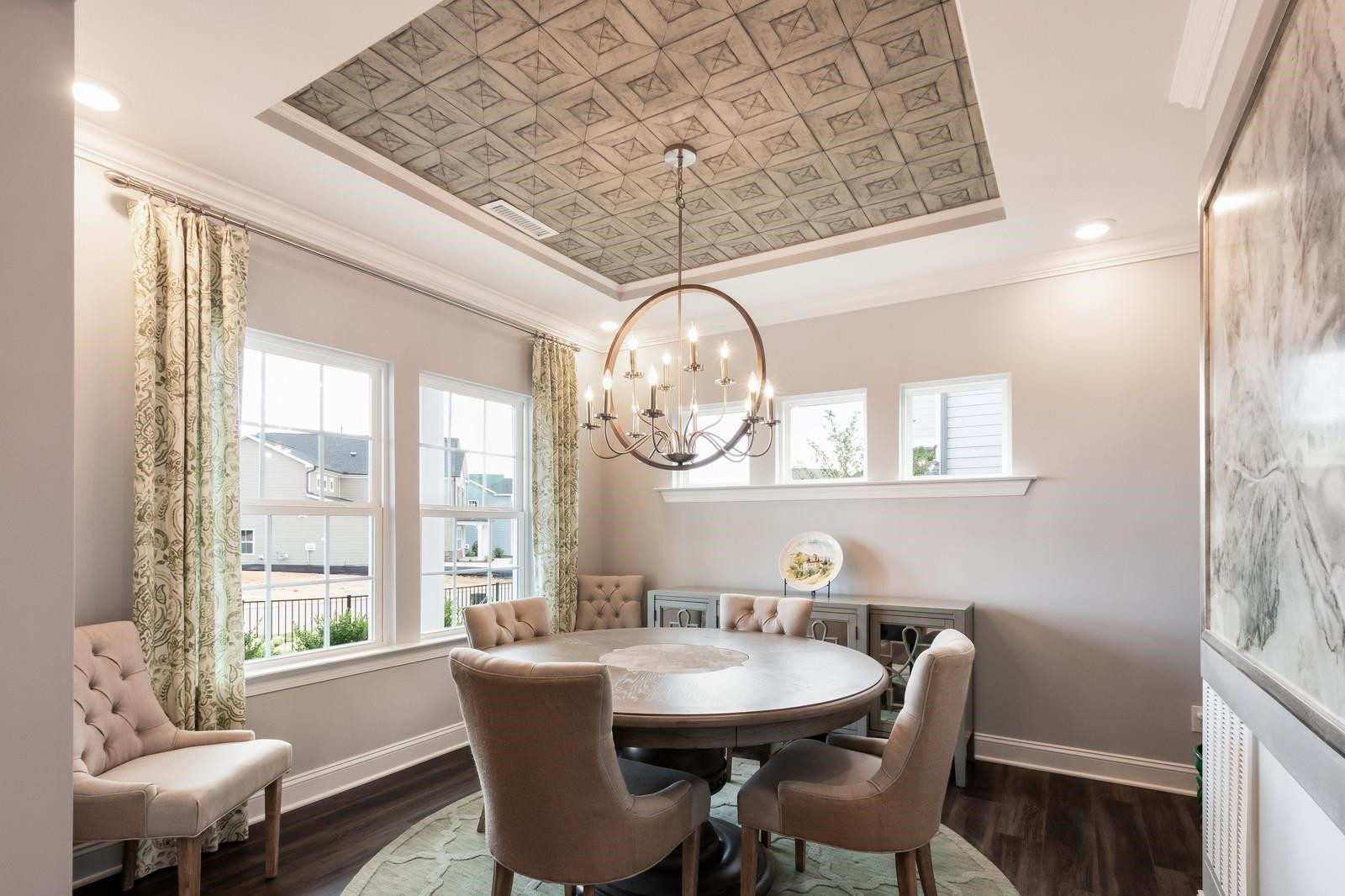 4121 Snowy Range Circle, Unit LANDRUM Raleigh, NC 27616 - Photo 6 of 27 a dining room with wooden floor a chandelier a wooden table and chairs