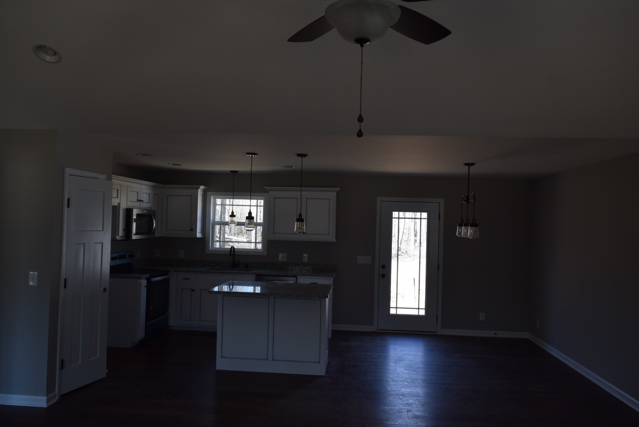 560 Ballard Road Manchester, TN 37355 - Photo 2 of 7 a kitchen with kitchen island stainless steel appliances and wooden floor