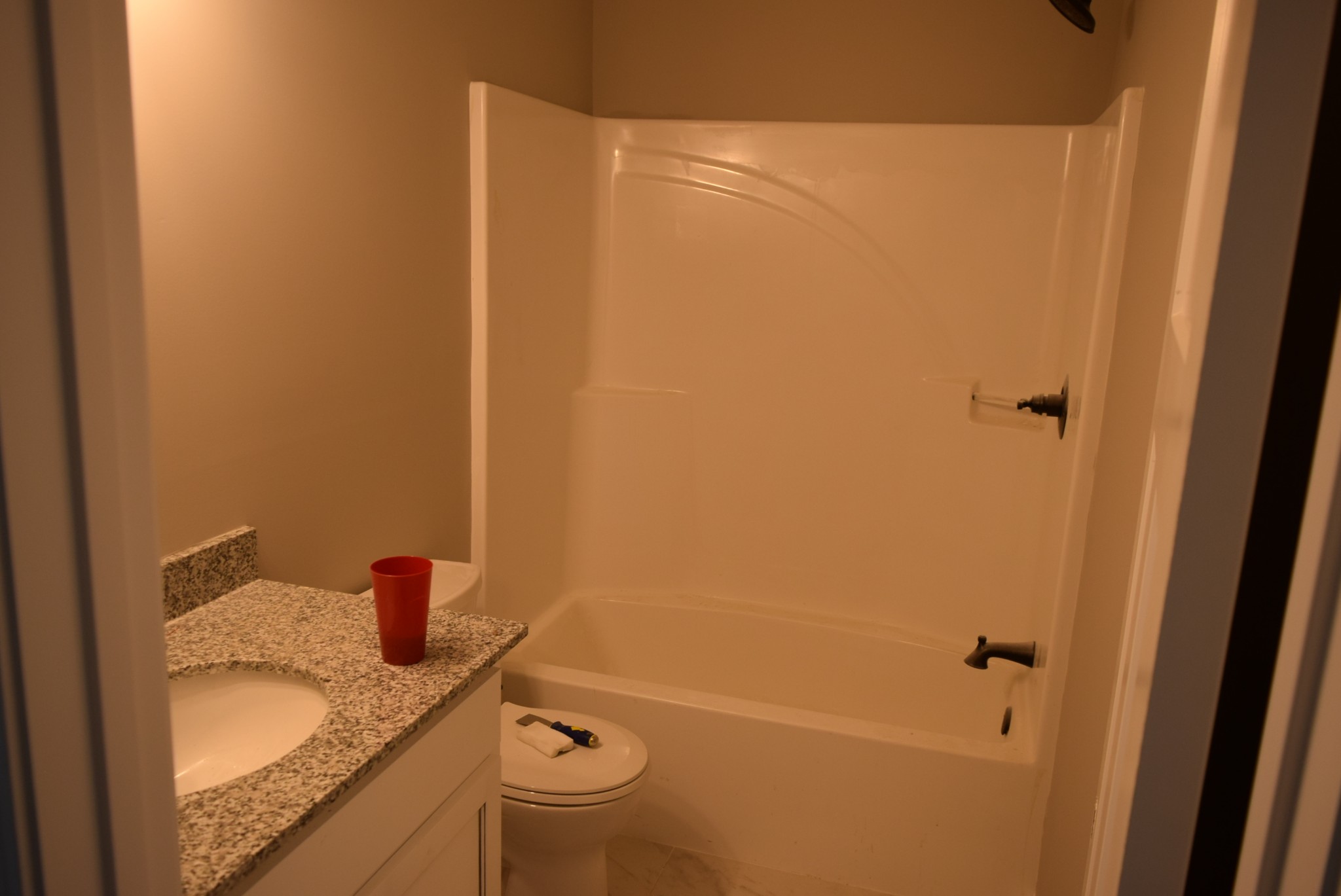 560 Ballard Road Manchester, TN 37355 - Photo 4 of 7 a bathroom with a granite countertop sink toilet and shower