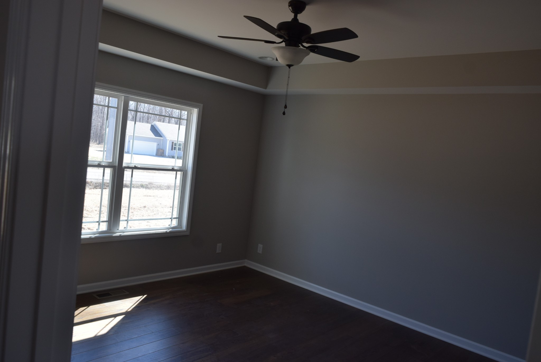 560 Ballard Road Manchester, TN 37355 - Photo 6 of 7 a view of an empty room with wooden floor and a window