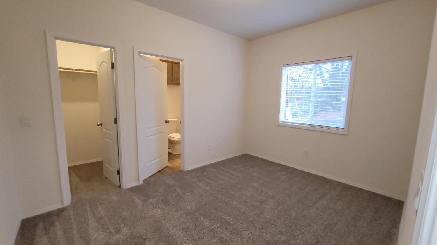 5812 Cedars Road, Unit 36 Redding, CA 96001 - Photo 8 of 9 an empty room with a window and a bathroom