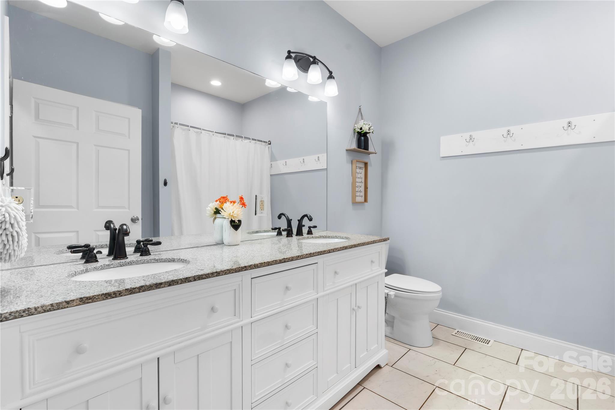111 Pinewood Road Granite Falls, NC 28630 - Photo 20 of 33 a bathroom with a toilet sink and mirror