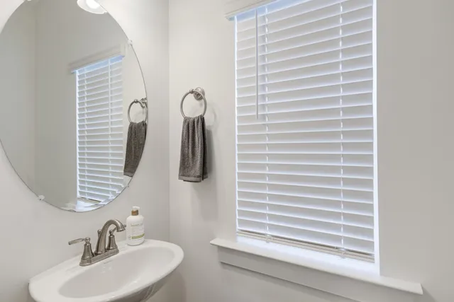 a bathroom with a sink a vanity and a large mirror