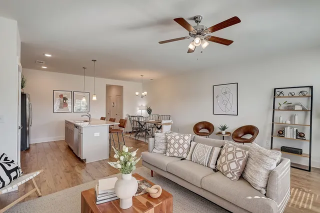 a kitchen with a table chairs refrigerator and microwave