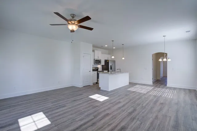 a view of a hallway with windows and chandelier