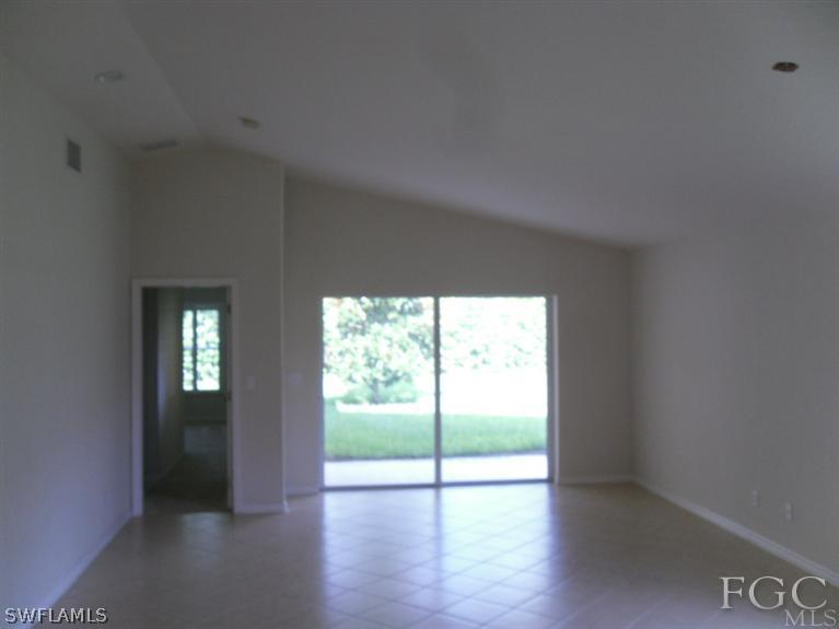 19710 Villa Rosa Loop Fort Myers, FL 33967 - Photo 3 of 5 a view of an empty room with wooden floor and a window