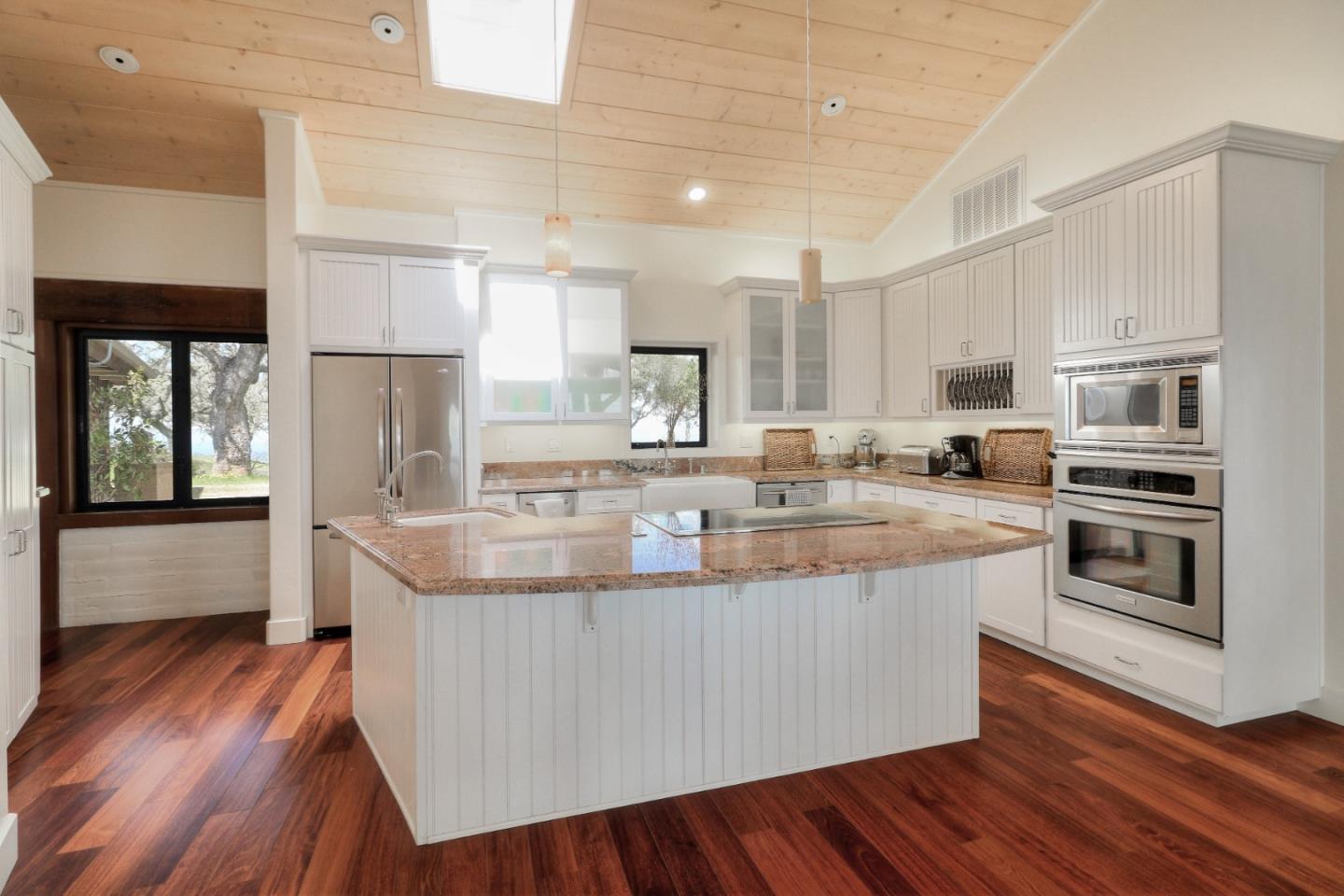 500 El Caminito Road Carmel Valley, CA 93924 - Photo 31 of 105 a kitchen with kitchen island granite countertop wooden floors and stainless steel appliances