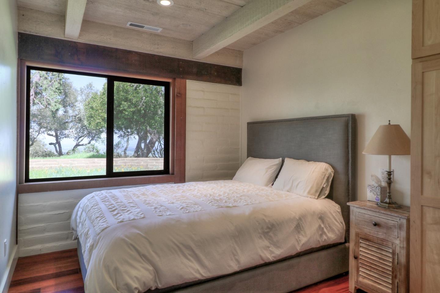 500 El Caminito Road Carmel Valley, CA 93924 - Photo 44 of 105 a bedroom with a large bed and a large window