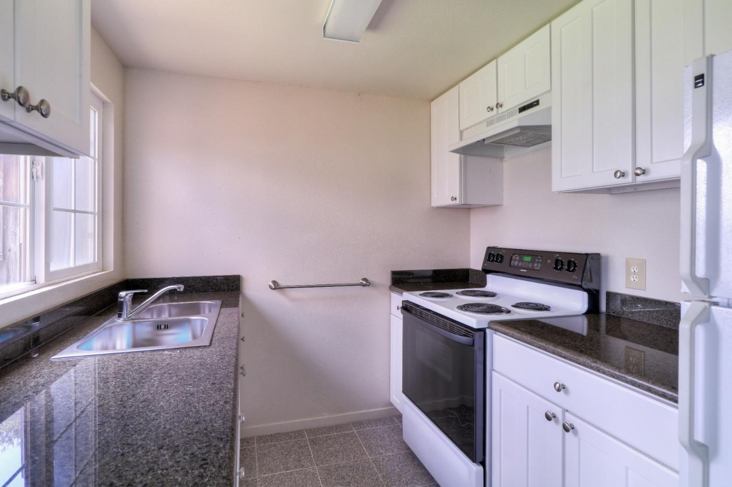 500 El Caminito Road Carmel Valley, CA 93924 - Photo 61 of 105 a white kitchen with granite countertop stainless steel appliances