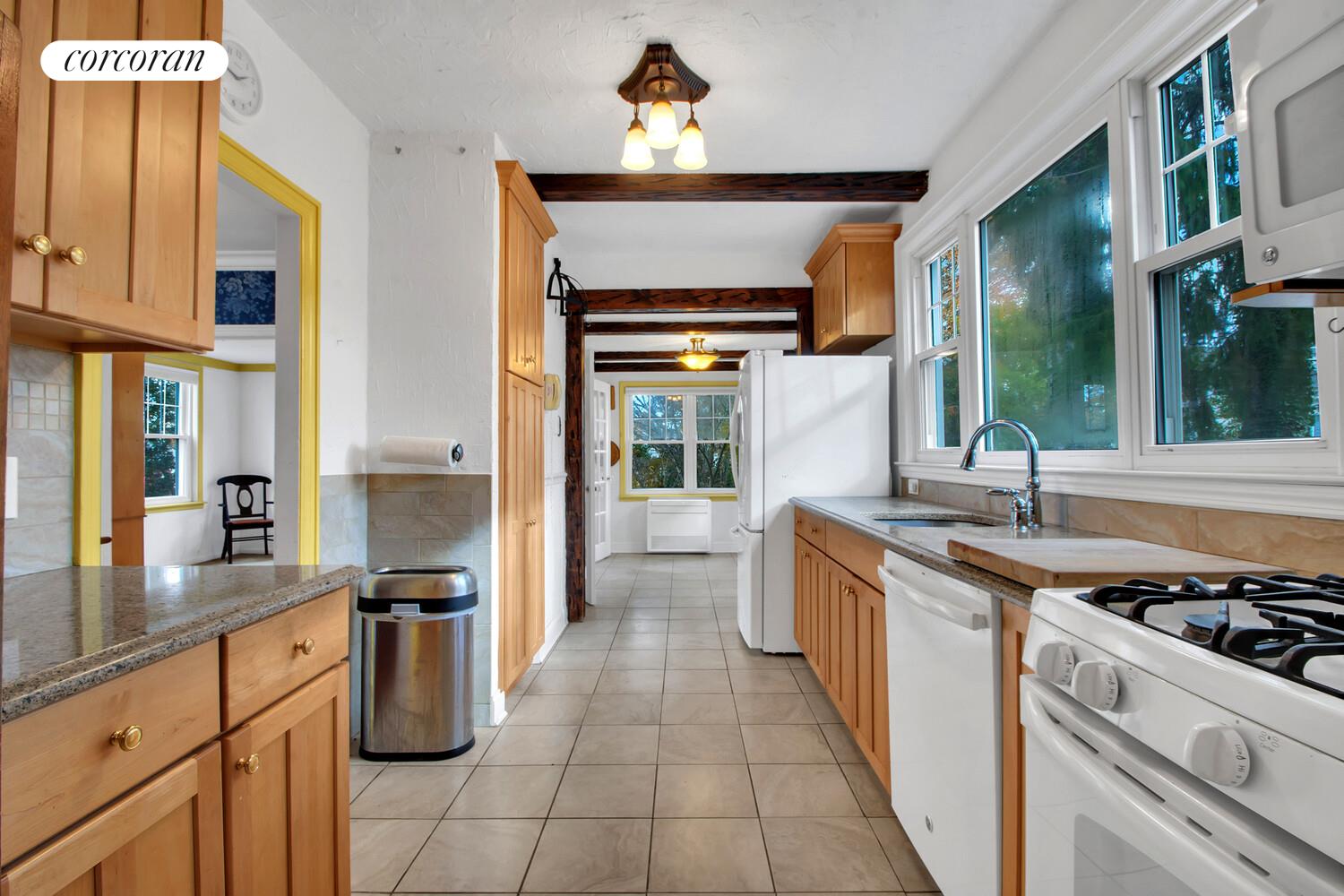 324 Beverly Road Queens, NY 11363 - Photo 11 of 20 a kitchen with stainless steel appliances a stove a sink and a refrigerator