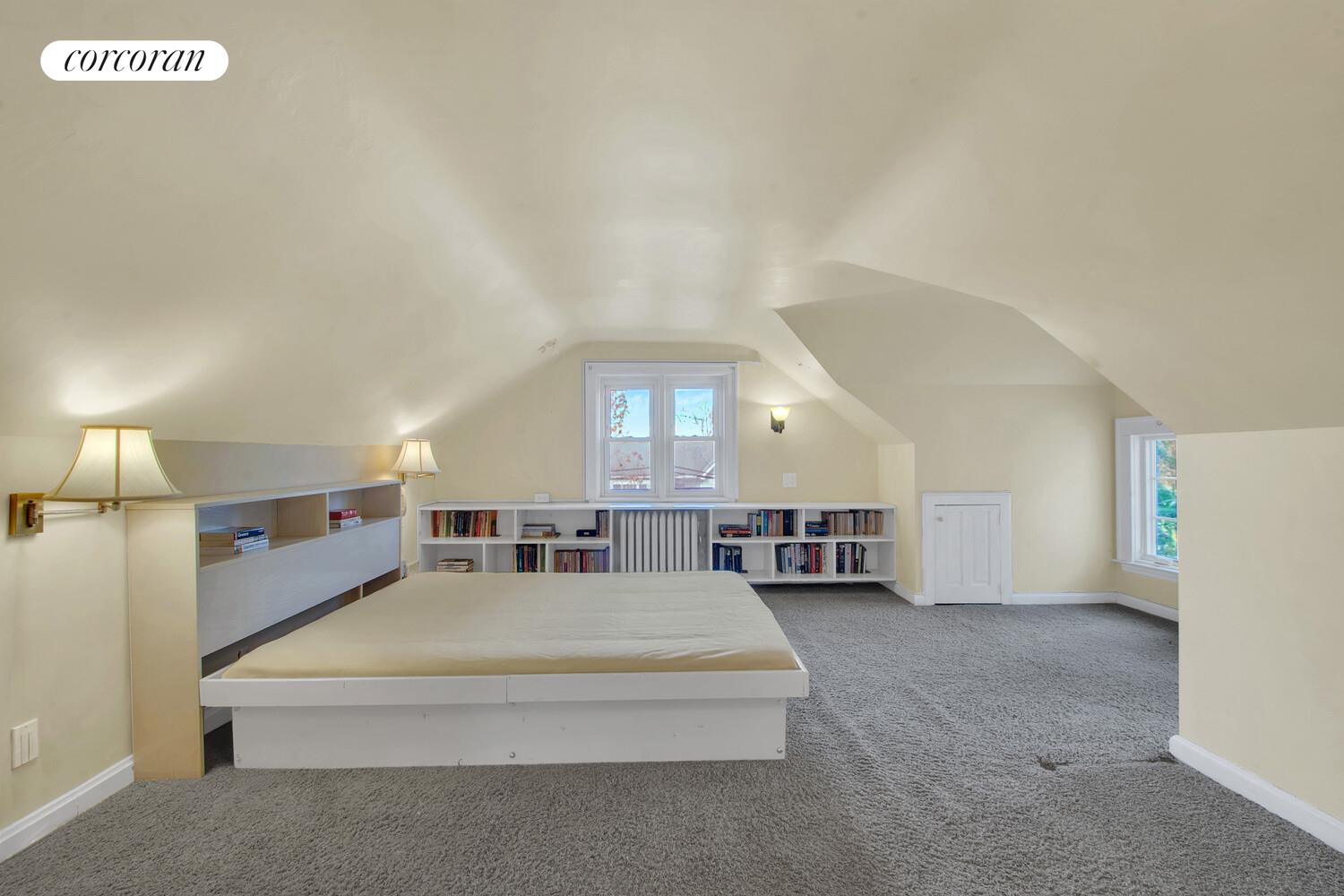 324 Beverly Road Queens, NY 11363 - Photo 12 of 20 a spacious bedroom with a bed and a large window