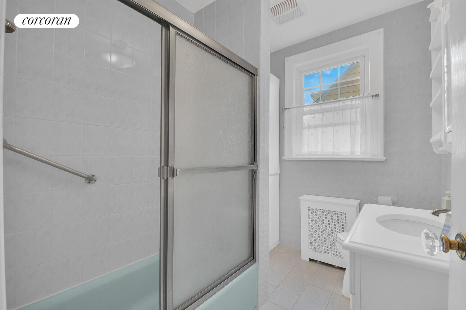 324 Beverly Road Queens, NY 11363 - Photo 16 of 20 a bathroom with a sink a toilet and a shower