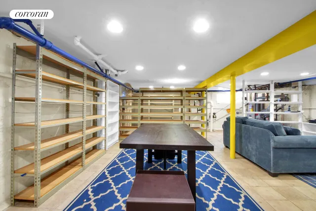 a living room with furniture a rug and white walls