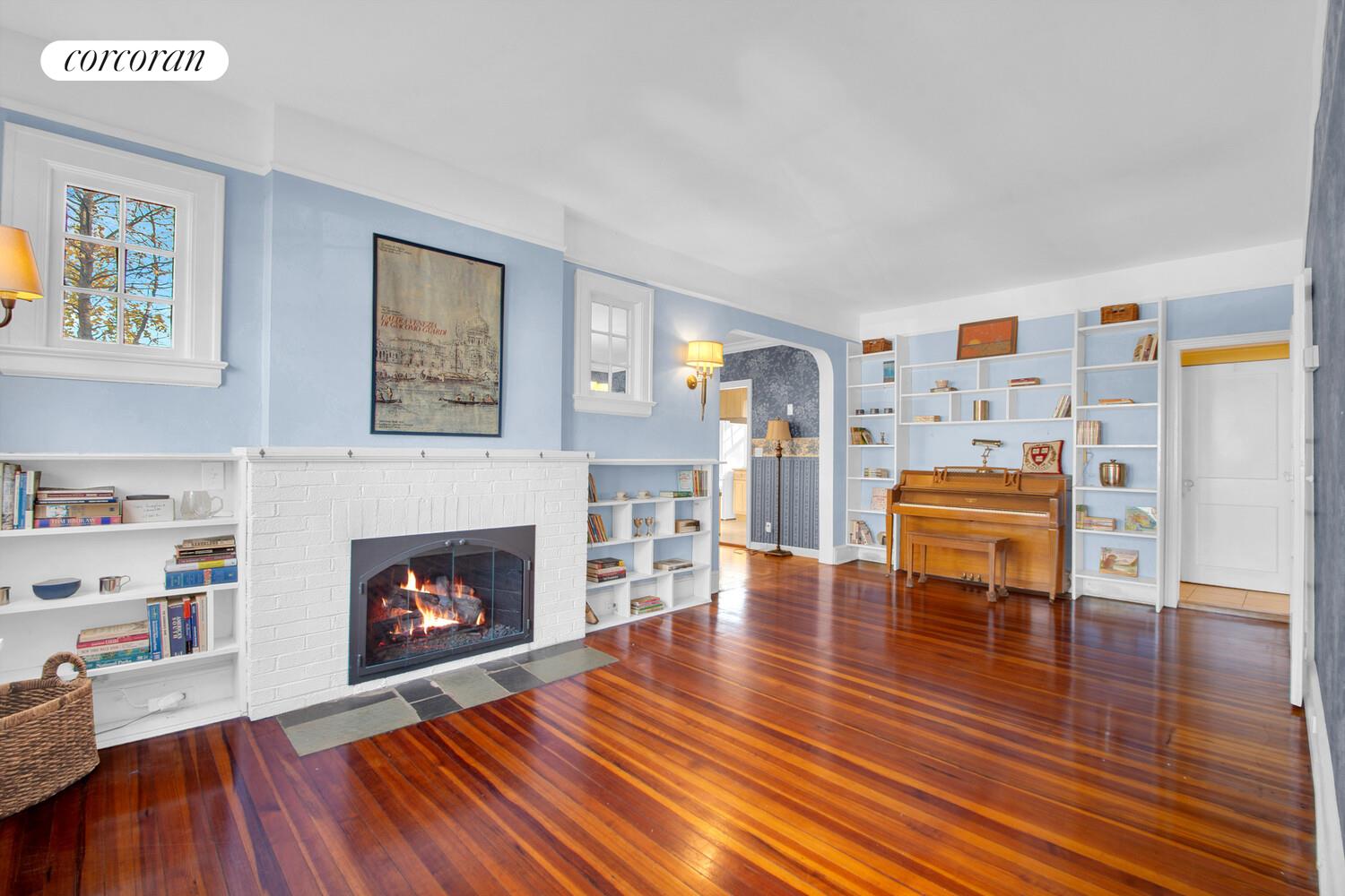 324 Beverly Road Queens, NY 11363 - Photo 3 of 20 a living room with furniture and a fireplace