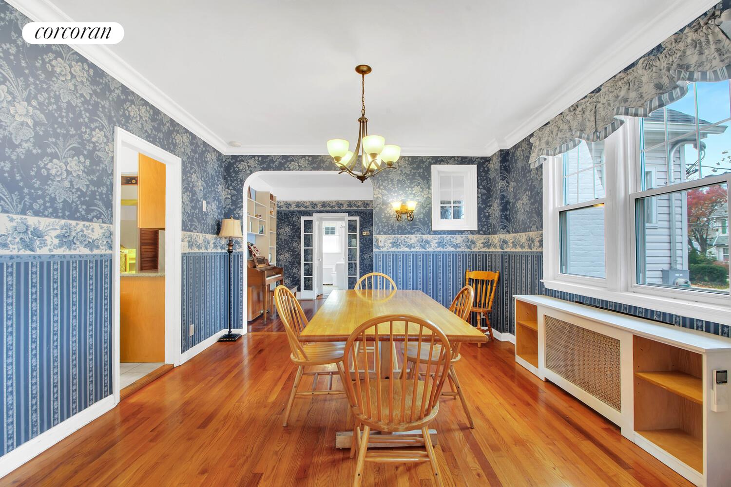 324 Beverly Road Queens, NY 11363 - Photo 7 of 20 a view of a dining room with furniture a chandelier and wooden floor