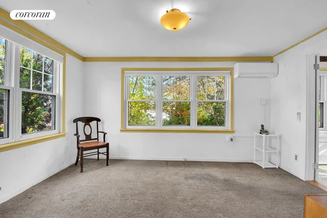 a view of a dining room with furniture a chandelier and wooden floor