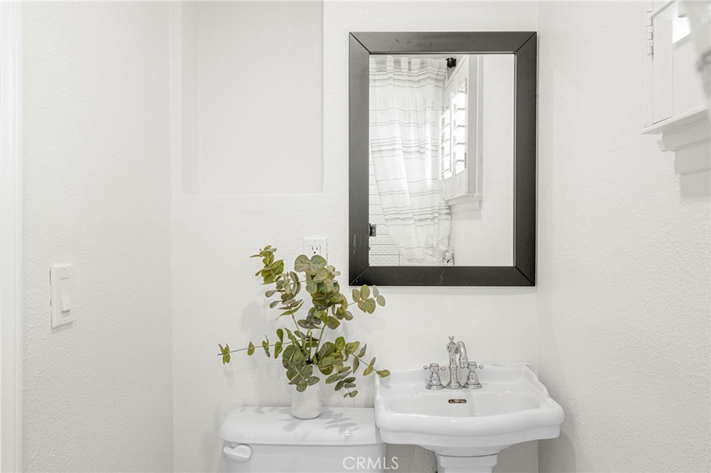 13007 Duffield Avenue La Mirada, CA 90638 - Photo 26 of 33 a bathroom with a sink a mirror and a window