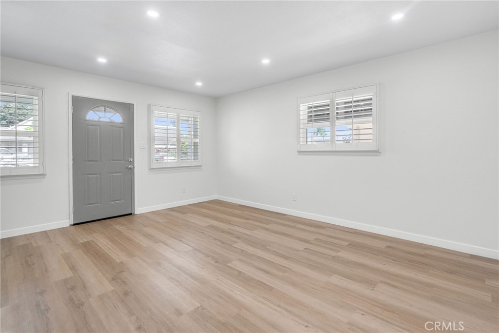 13007 Duffield Avenue La Mirada, CA 90638 - Photo 8 of 33 a view of an empty room with wooden floor and a window