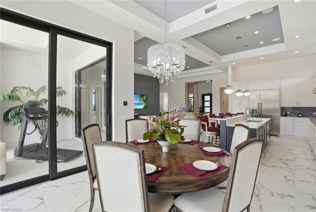 19086 Via Messina Way Miromar Lakes, FL 33913 - Photo 11 of 50 a view of a dining room with furniture and chandelier