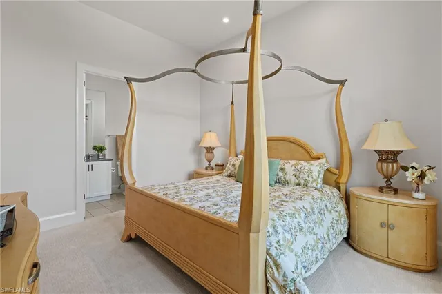 a bedroom with bed and a chandelier