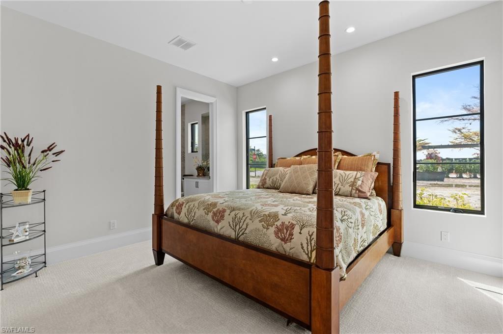 19086 Via Messina Way Miromar Lakes, FL 33913 - Photo 18 of 46 a bedroom with a bed lamp and a window