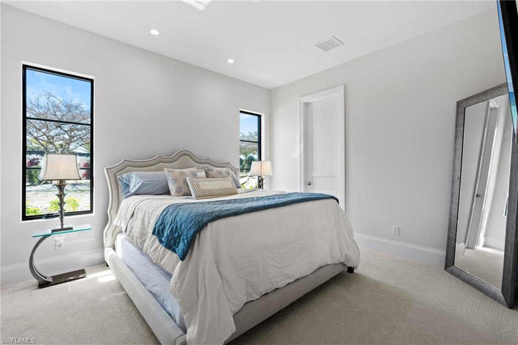 19086 Via Messina Way Miromar Lakes, FL 33913 - Photo 21 of 46 a bedroom with a bed and a window