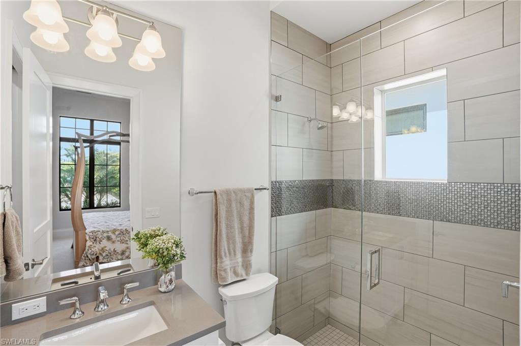 19086 Via Messina Way Miromar Lakes, FL 33913 - Photo 22 of 50 a bathroom with a sink toilet and shower