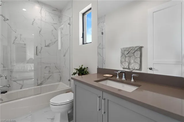 a bathroom with a sink a toilet and bathtub