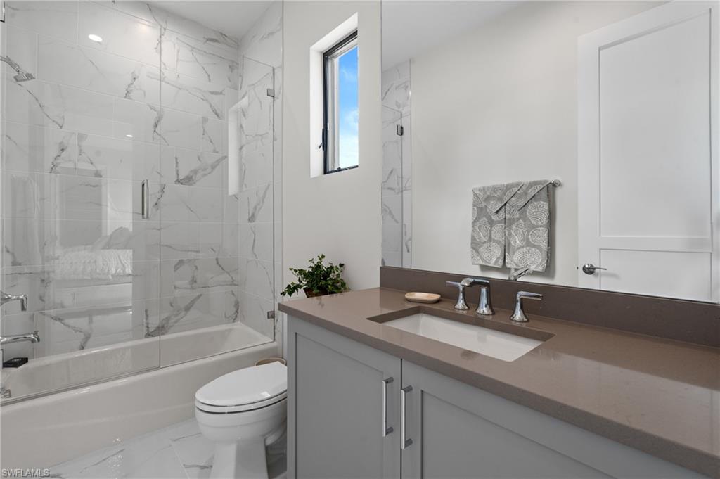 19086 Via Messina Way Miromar Lakes, FL 33913 - Photo 23 of 46 a bathroom with a sink a toilet and bathtub