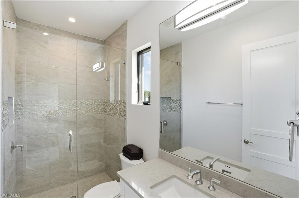 19086 Via Messina Way Miromar Lakes, FL 33913 - Photo 25 of 50 a bathroom with a sink a toilet and shower