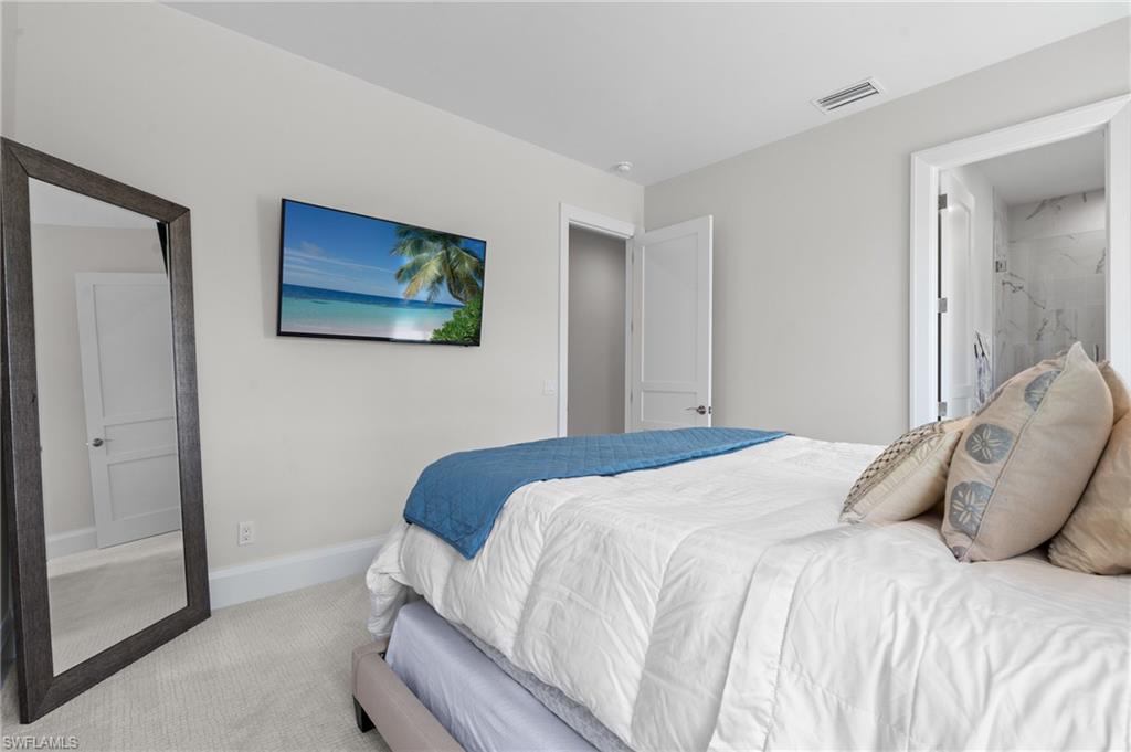 19086 Via Messina Way Miromar Lakes, FL 33913 - Photo 27 of 50 a bedroom with a bed and a painting on the wall