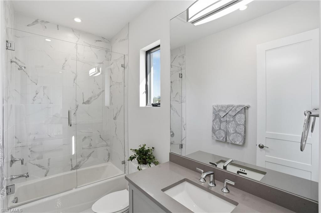 19086 Via Messina Way Miromar Lakes, FL 33913 - Photo 28 of 50 a bathroom with a sink mirror toilet and bathtub