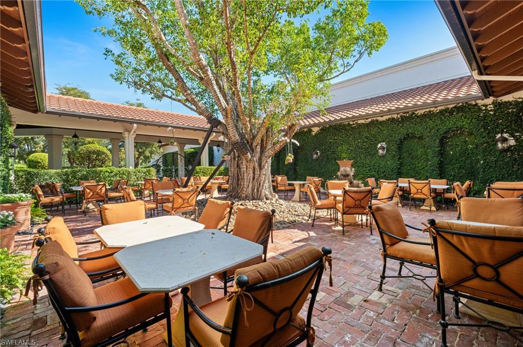 19086 Via Messina Way Miromar Lakes, FL 33913 - Photo 38 of 46 a view of a patio with table and chairs and potted plants