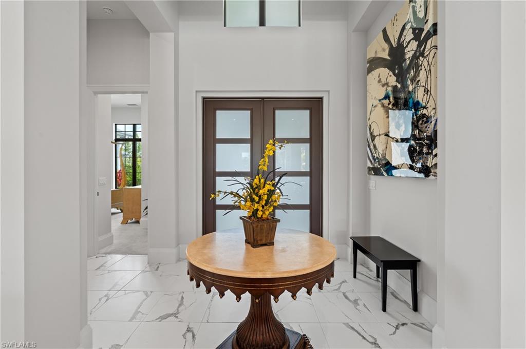 19086 Via Messina Way Miromar Lakes, FL 33913 - Photo 5 of 46 a room with a table and chairs