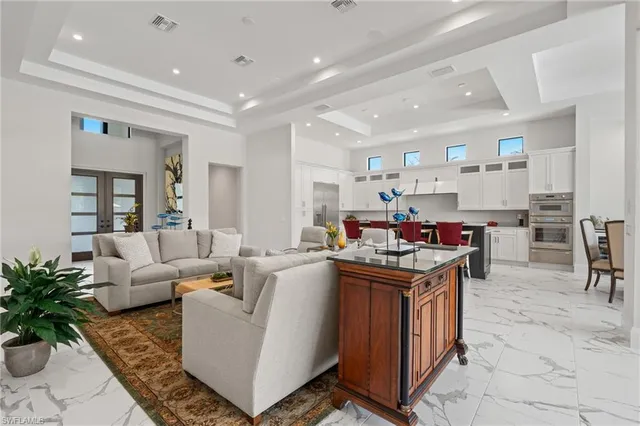 a living room with furniture and a dining table