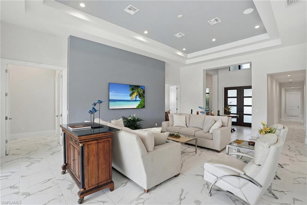 19086 Via Messina Way Miromar Lakes, FL 33913 - Photo 7 of 50 a living room with furniture and a flat screen tv