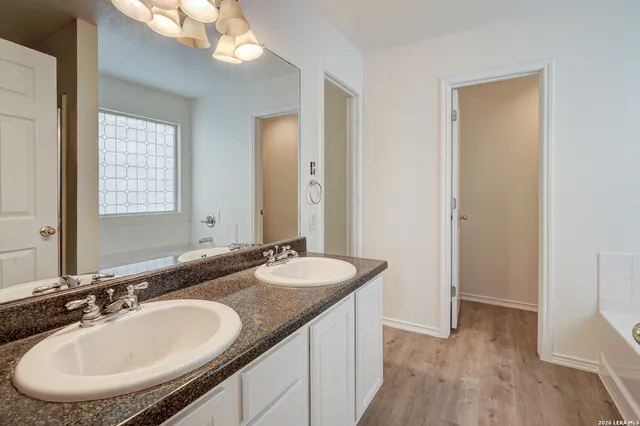 a bathroom with a sink double vanity and a mirror