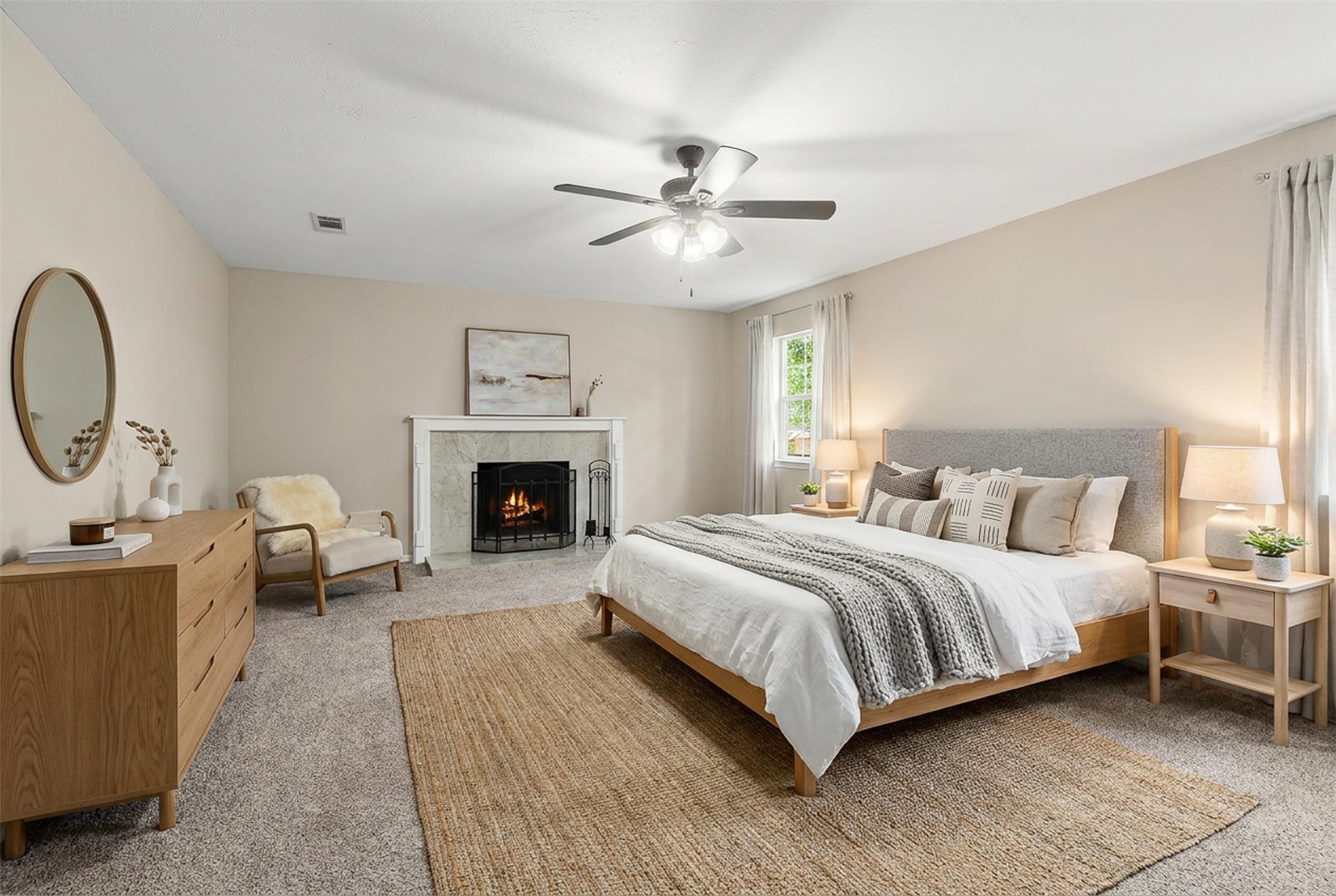 4238 Annawood Circle Spring, TX 77388 - Photo 19 of 46 a spacious bedroom with a bed a fireplace and a chandelier