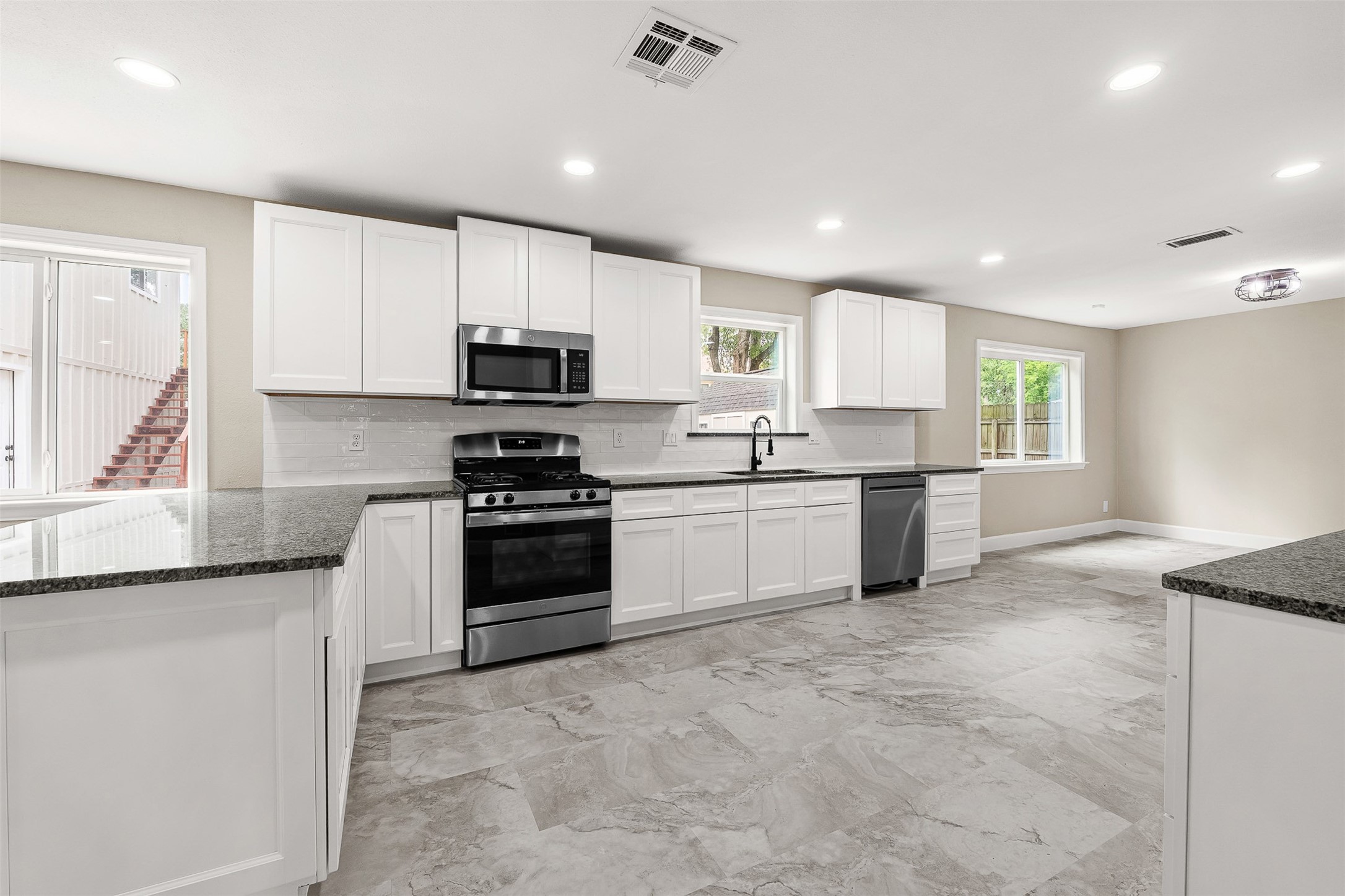 4238 Annawood Circle Spring, TX 77388 - Photo 8 of 46 a kitchen with granite countertop white cabinets and stainless steel appliances