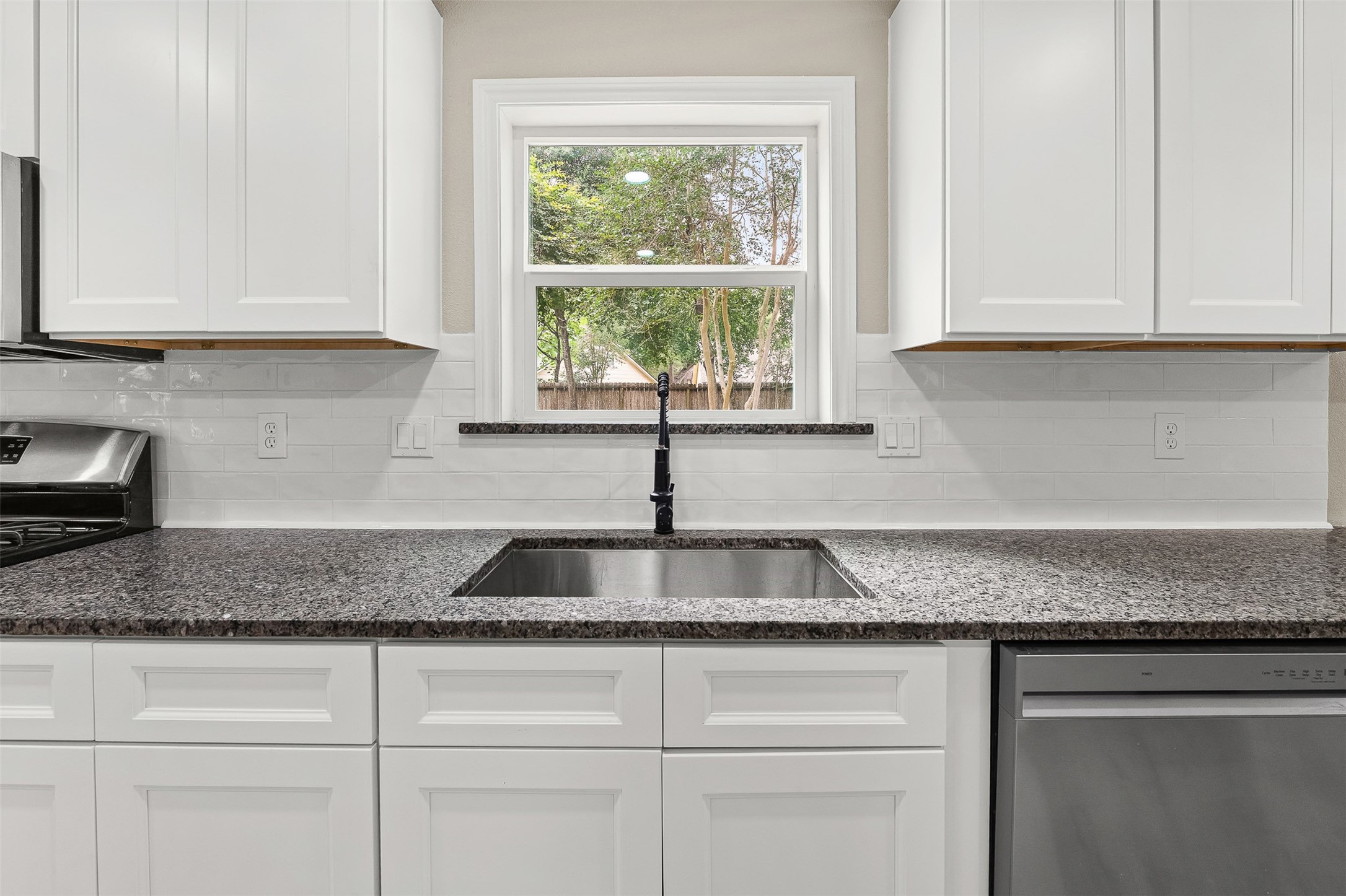 4238 Annawood Circle Spring, TX 77388 - Photo 10 of 46 a kitchen with granite countertop white cabinets and window