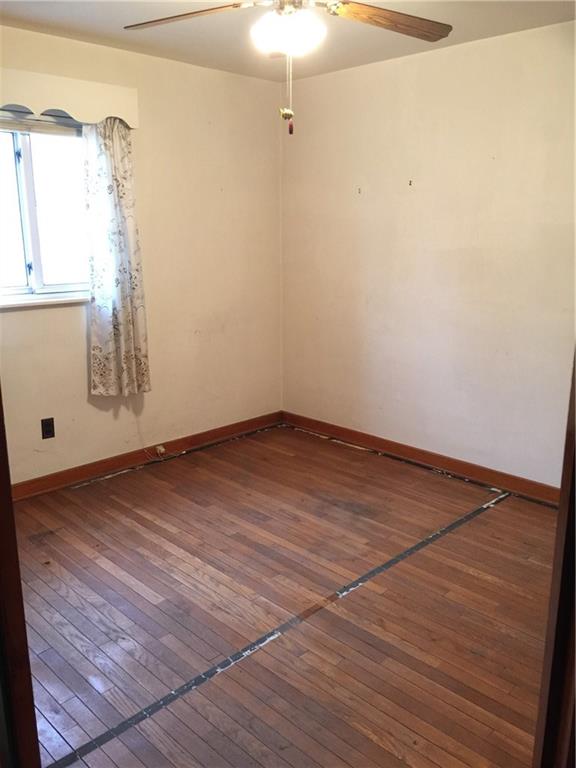 3rd Bedroom, 10x11, Nice Hardwood Floors!  The black lines on the floor are leftover tape that held the carpet in place.