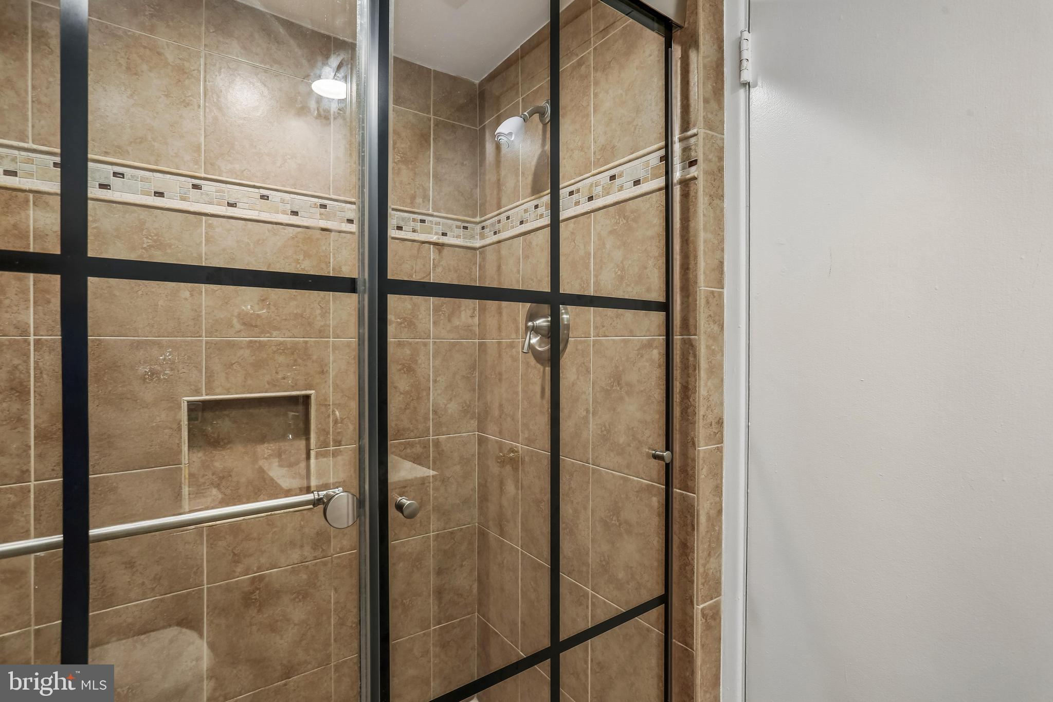 2 Foxhall Court Silver Spring, MD 20906 - Photo 59 of 86 a bathroom with a glass shower door and mirror