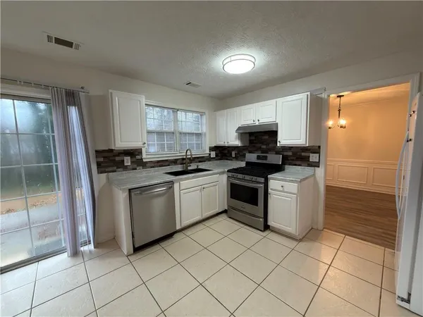 a kitchen with a sink a stove and refrigerator
