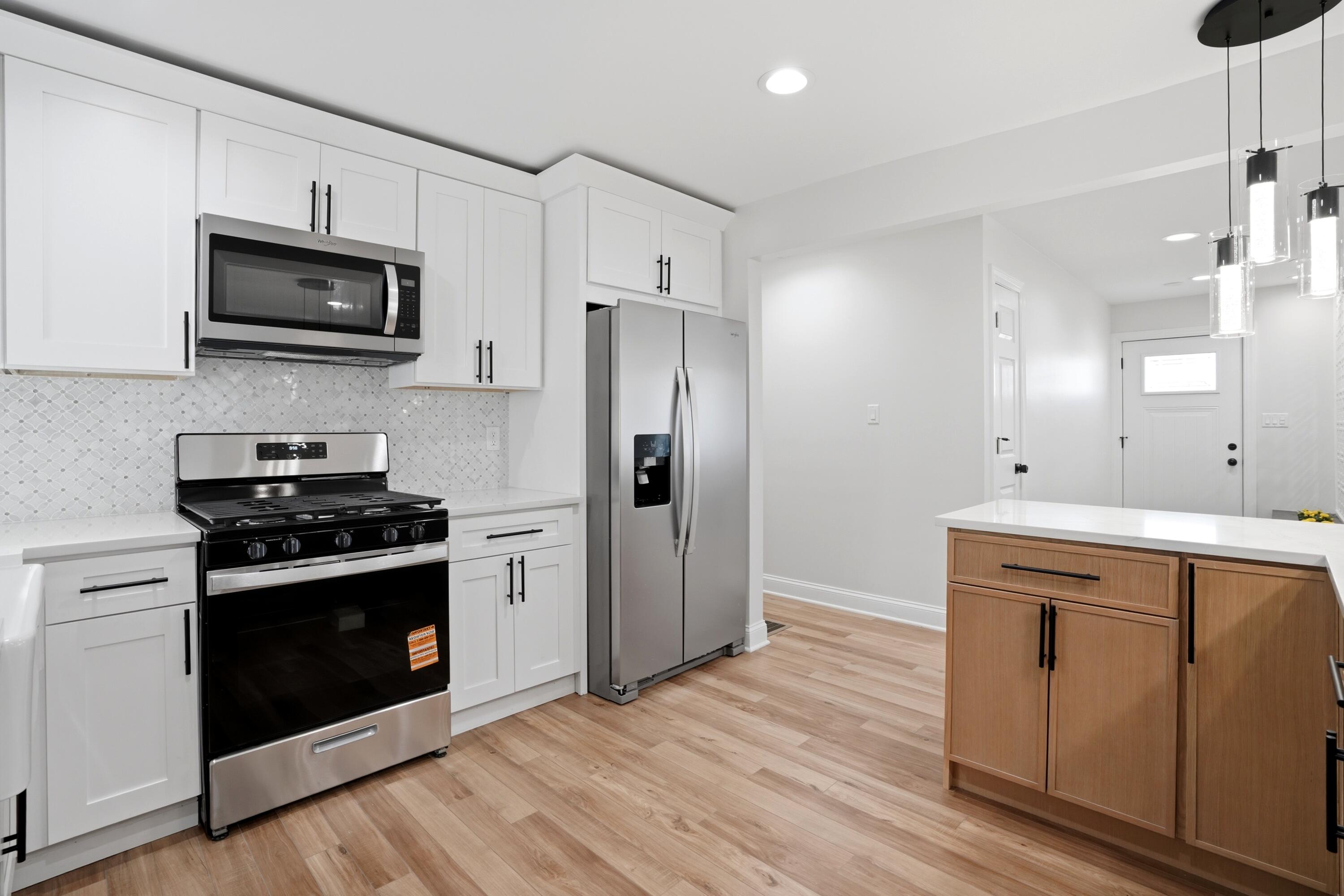 1960 Chase Street Gary, IN 46404 - Photo 6 of 45 a kitchen with stainless steel appliances granite countertop a stove a microwave and a refrigerator