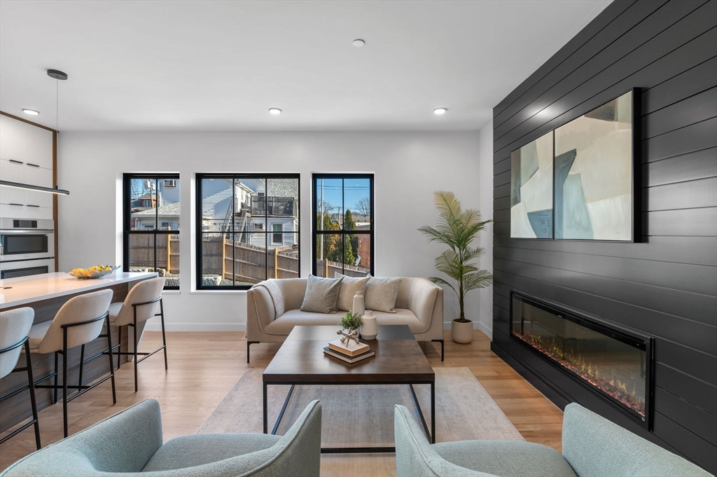 11 Boynton Street, Unit 103 Swampscott, MA 01907 - Photo 15 of 42 a living room with furniture and a large window