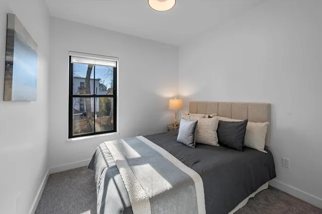 a view of a hallway with furniture and windows
